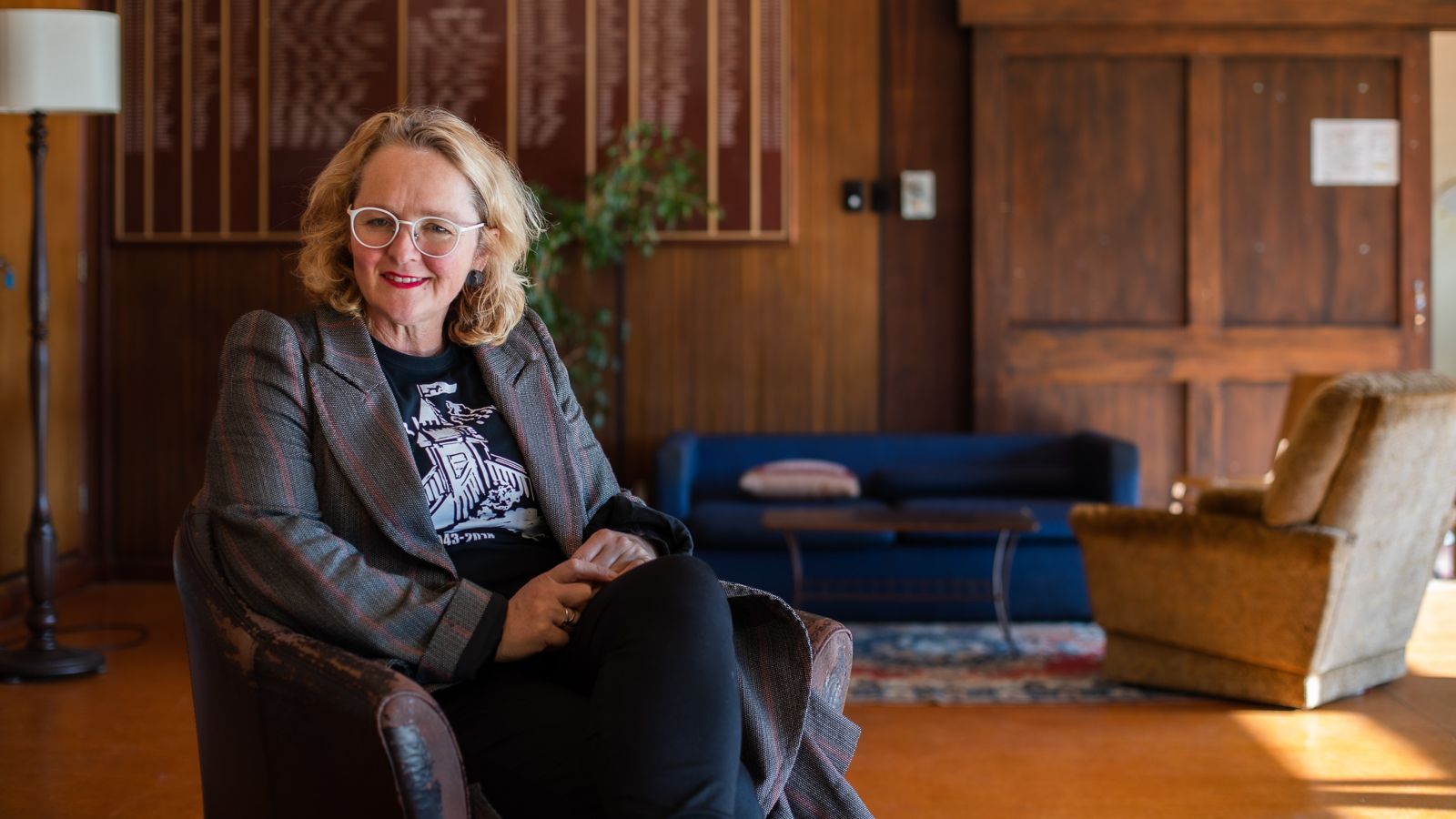 Sophie Jerram sitting on an old leather seat in a wooden room. 