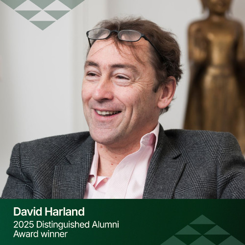 An image of David Harland, a pakeha man smiling with brown hair wearing a pink shirt.