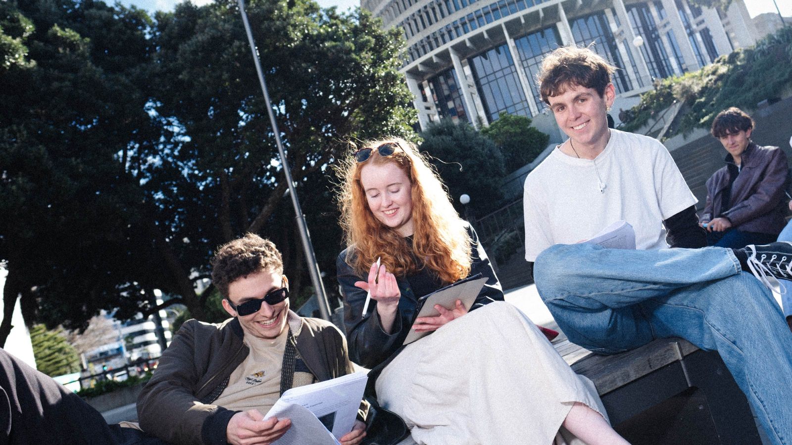 Three students studying outside of the Bee Hive in Wellington