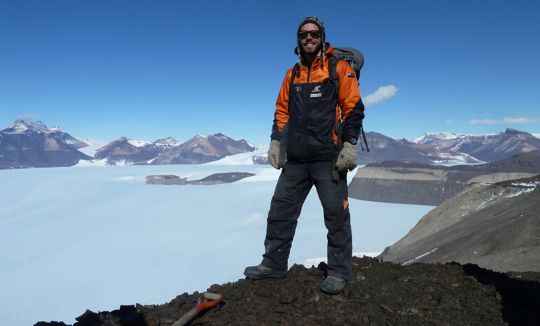 Chris Kraus above an Antarctic background of snow and ice on mountains and plains during the Antarctic field season Summer 2014