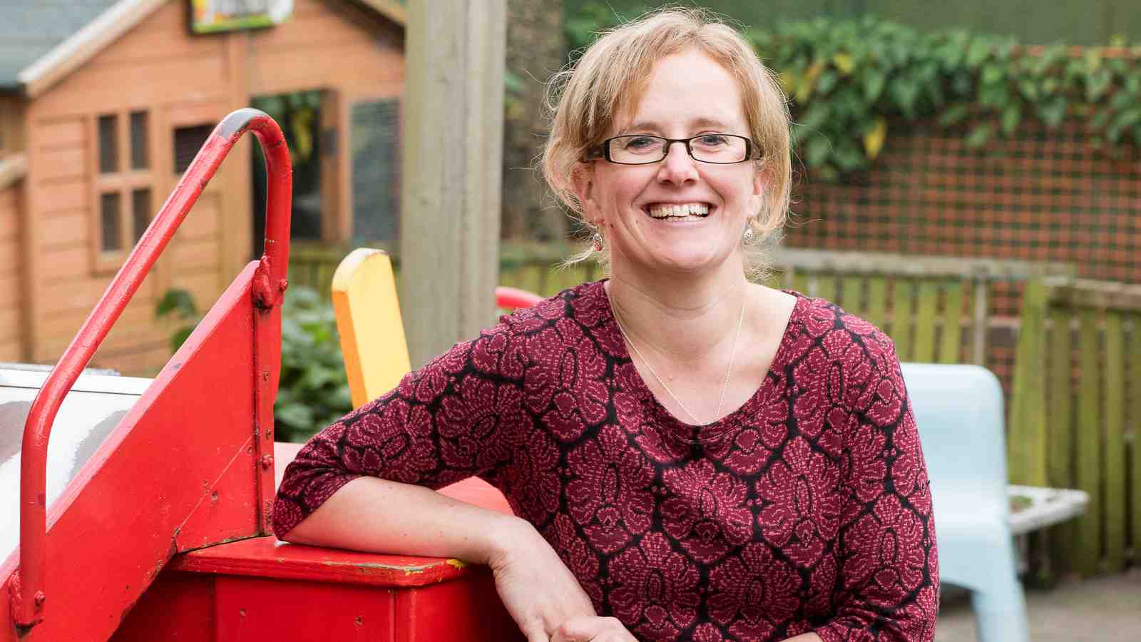 Miranda Major smiles in the playground of her preschool.