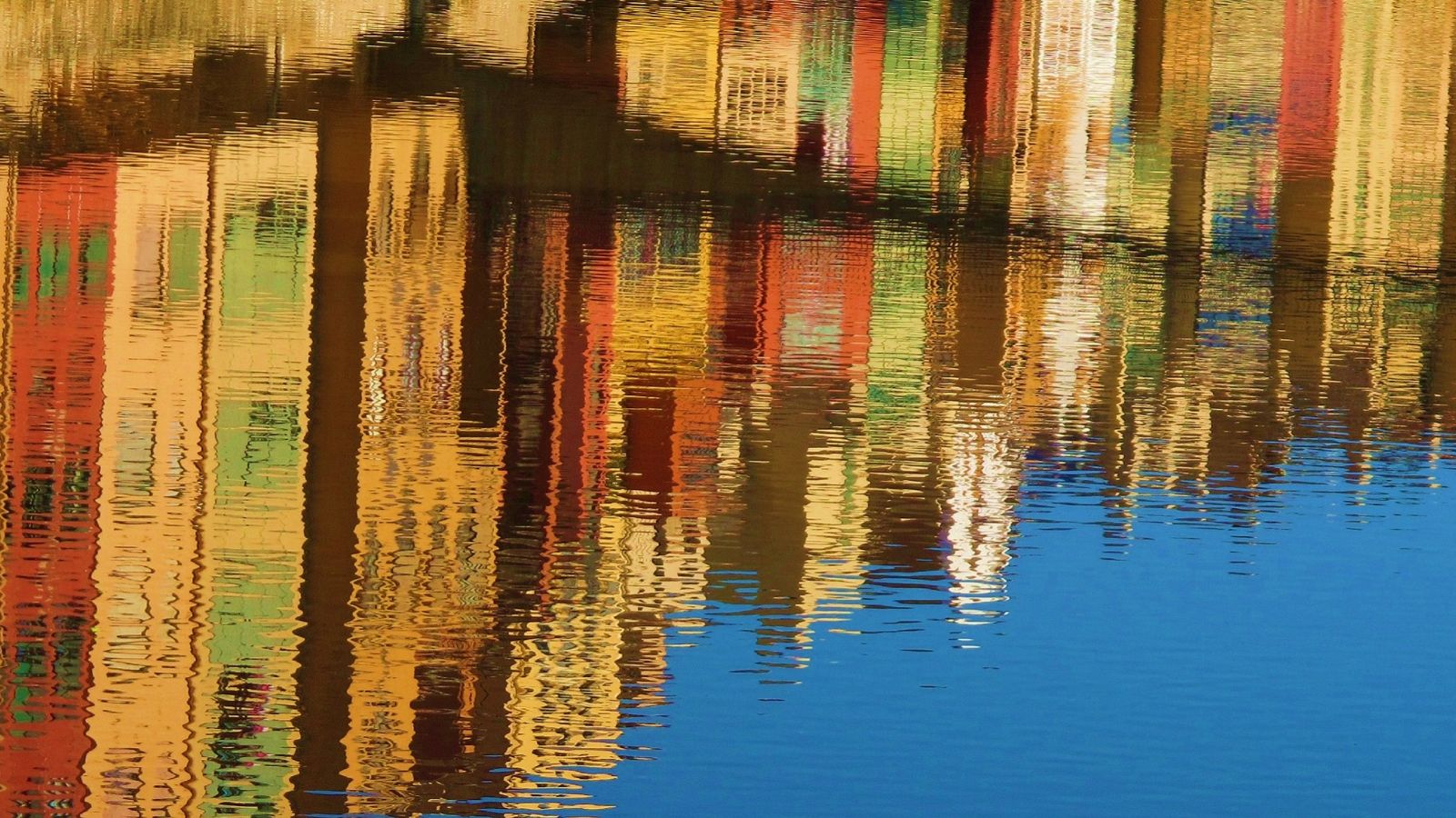 A reflection of buildings in the water.