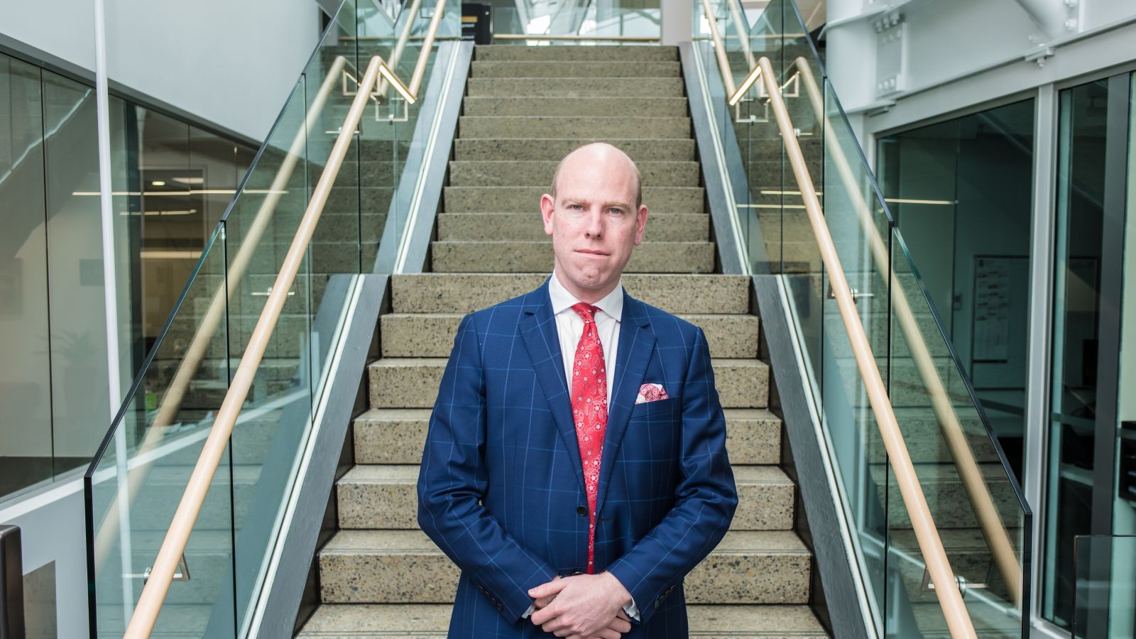 max rashbrooke with blue suit at bottom of stone stairs