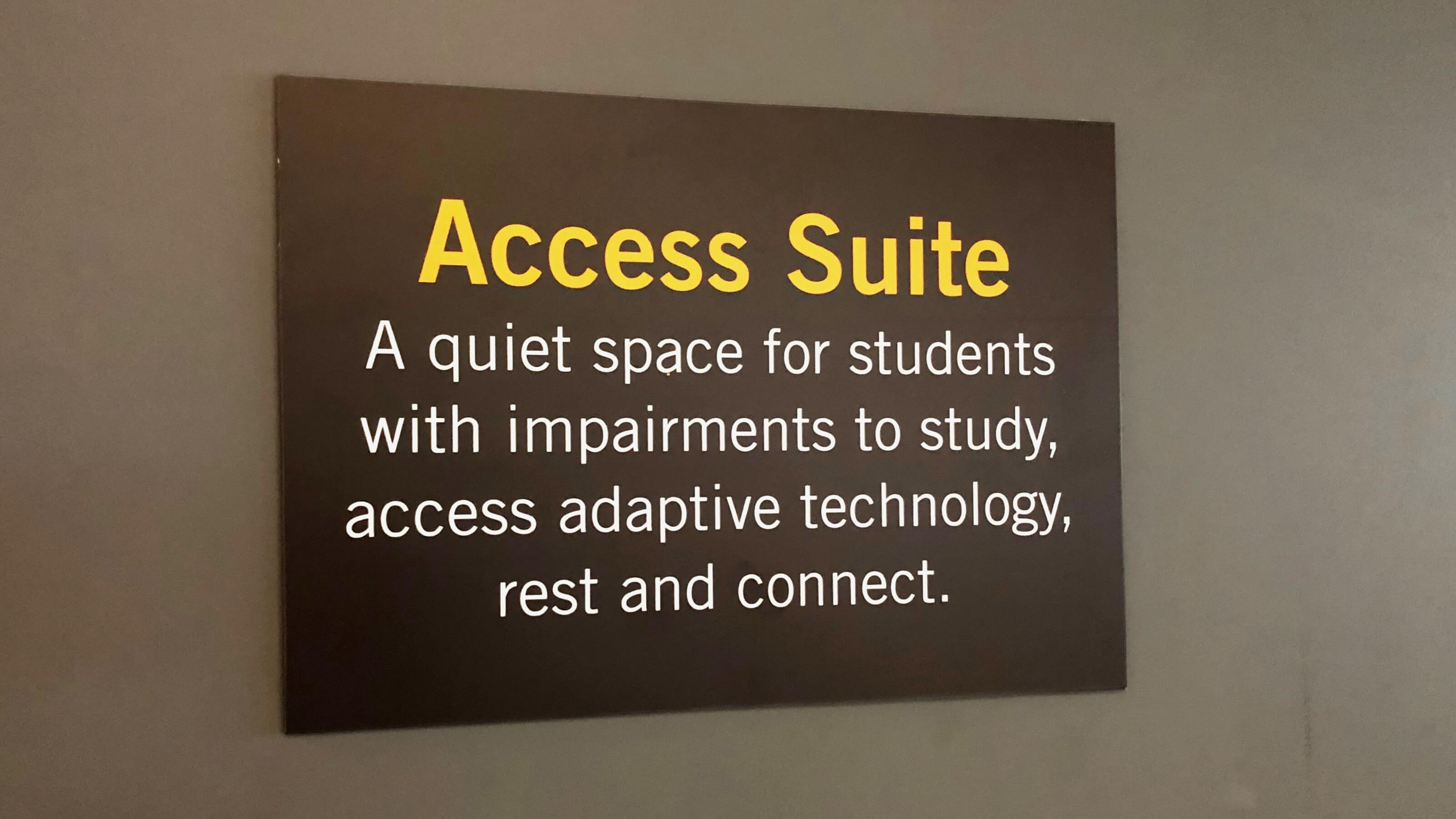 A sign that reads, “Access Suite – A quiet space for students with impairments to study, access adaptive technology, rest and connect”. 