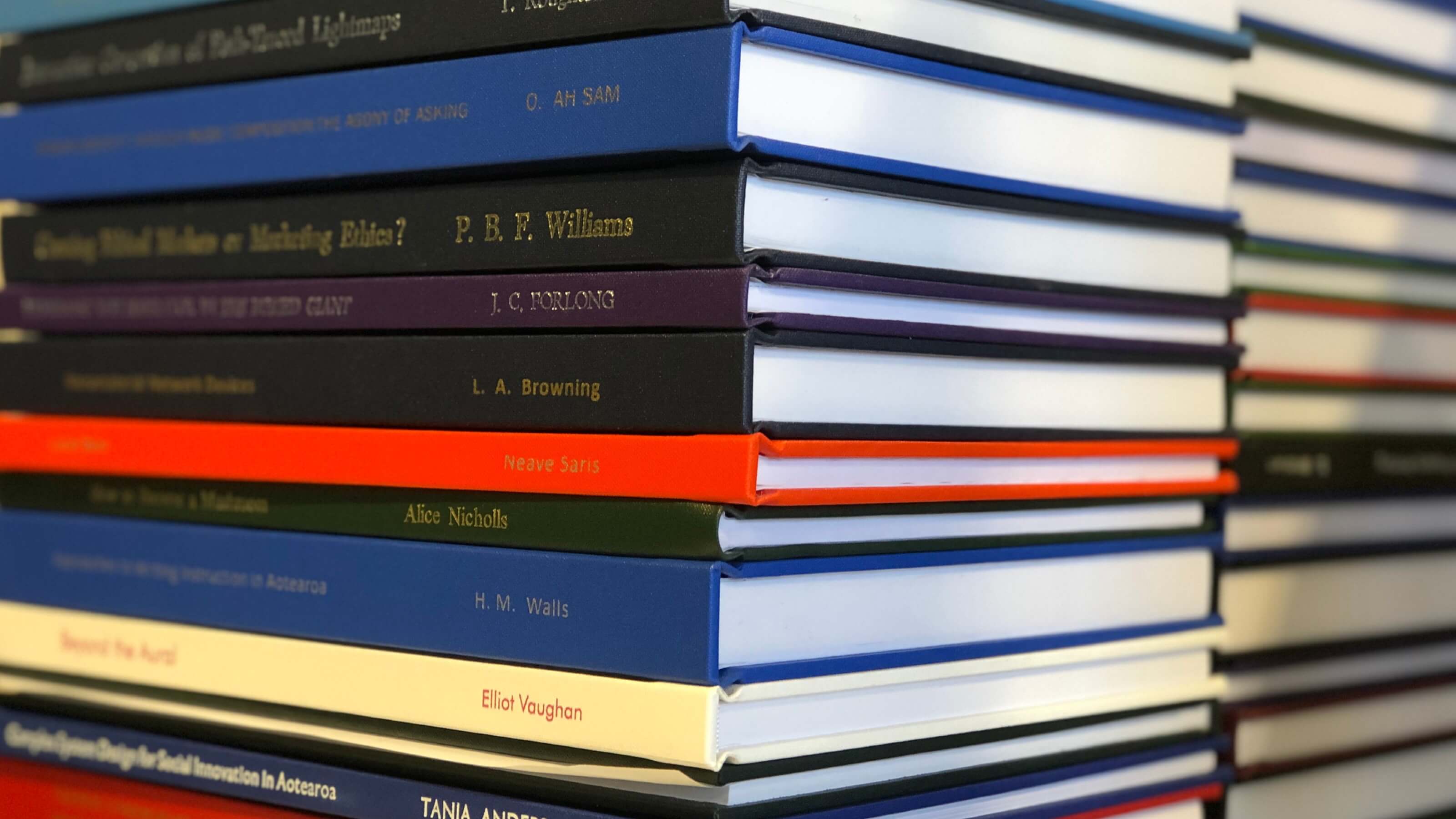 A close up image of a stack of hardcover books.