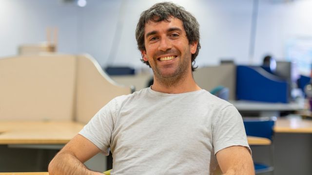 German Molina sitting in chair in classroom