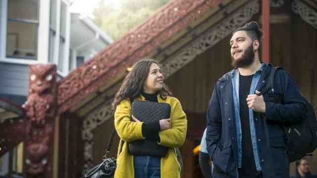 two Maori students in front of Te Herenga Waka marae