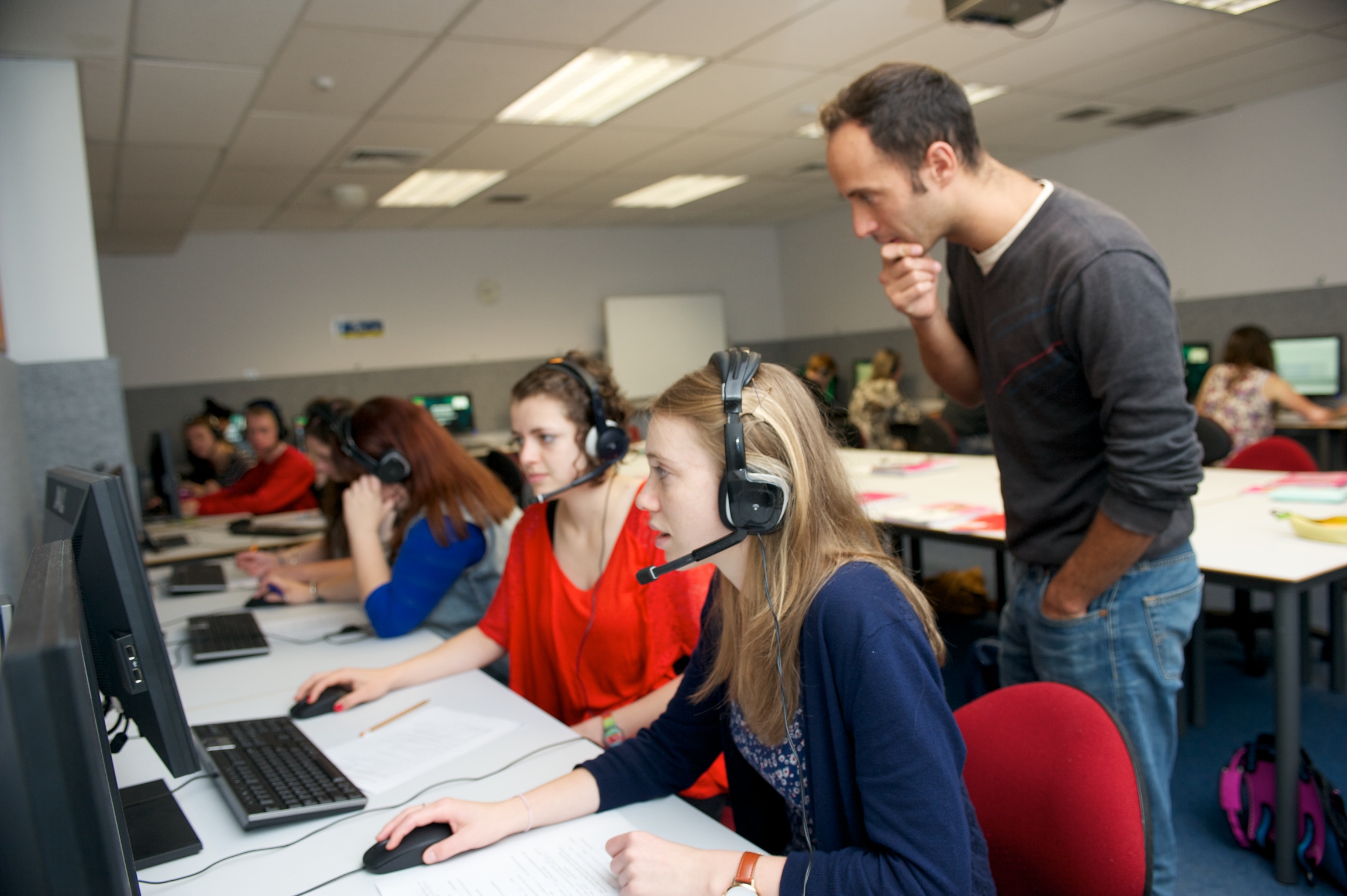 School of Languages and Cultures tutor Luc Arnault guiding students during a tutorial in one of the Language Learning Centre's teaching labs.
