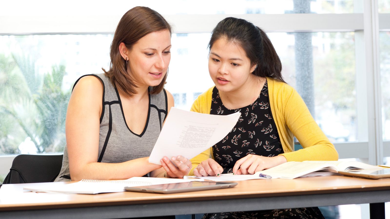 A lecturer and student reviewing a piece of work together