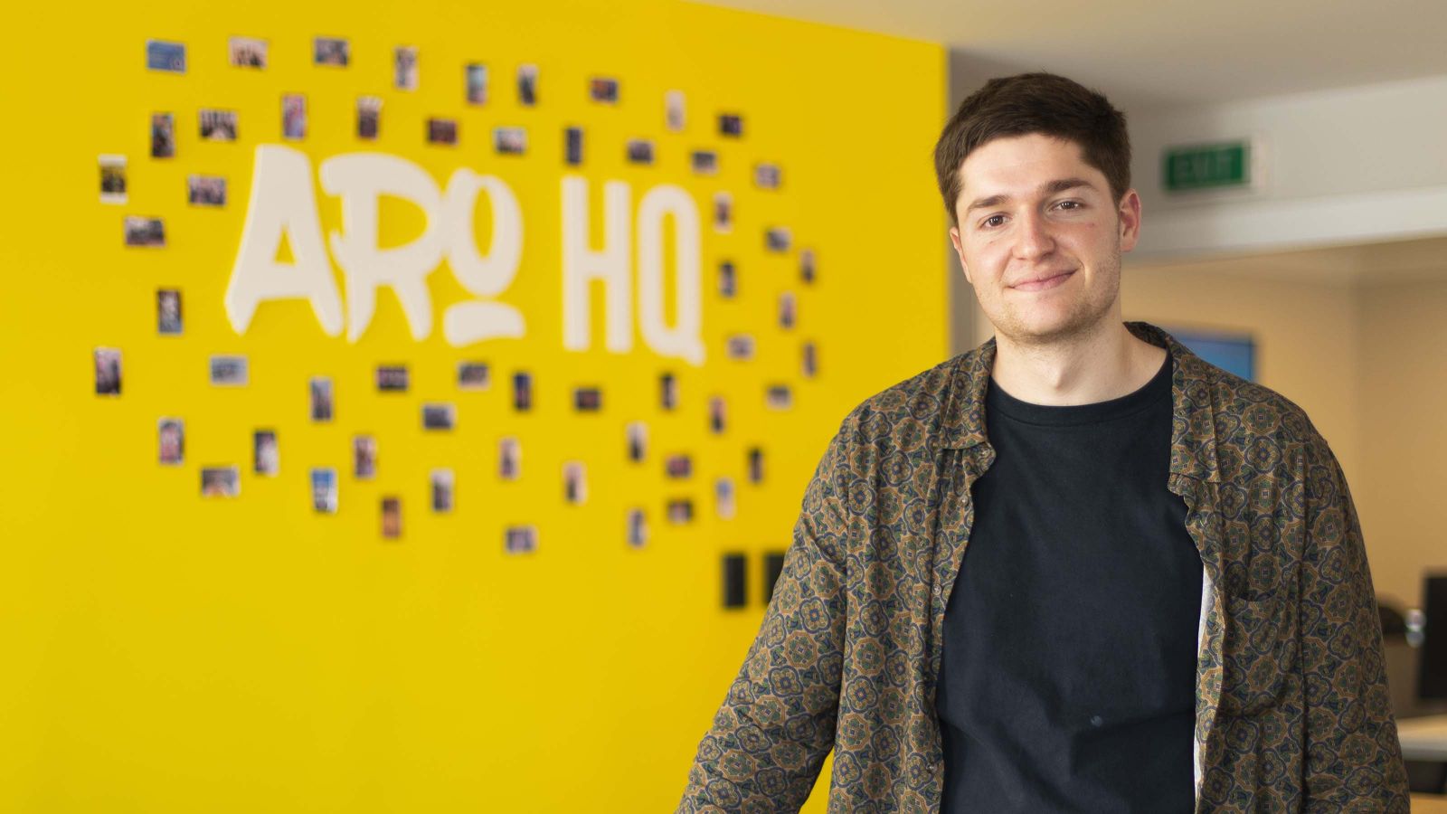 Daniel Raats stands in front of Aro HQ sign.