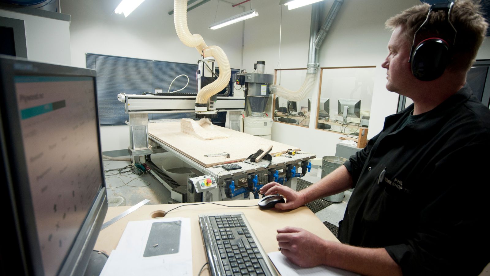 Technician using flatbed CNC router at Wellington Faculty of Architecture and Design Innovation