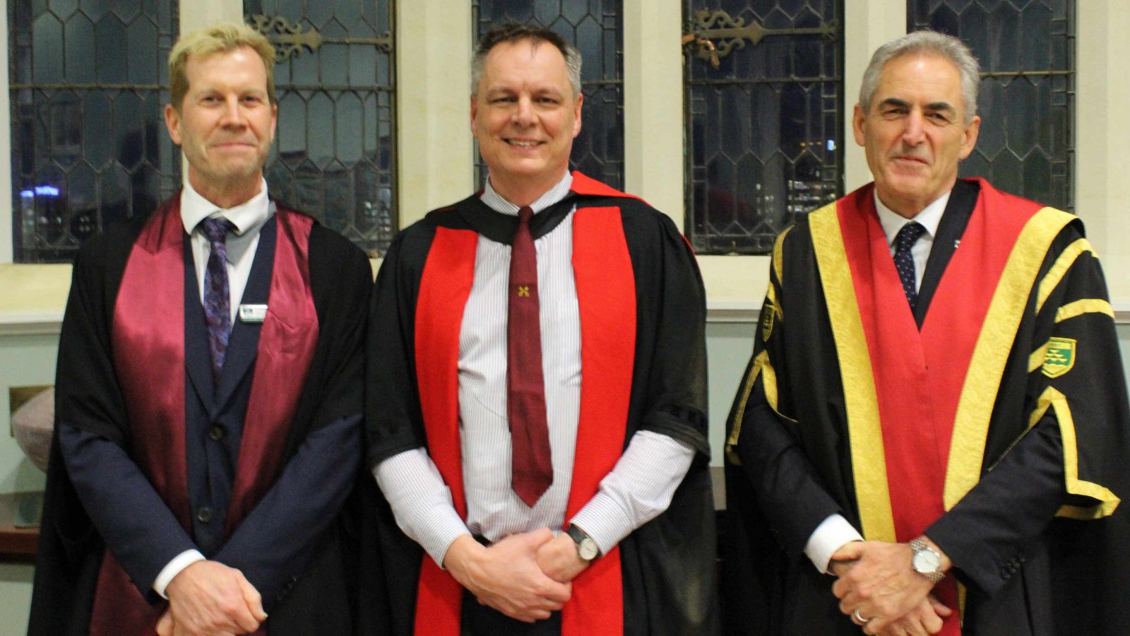 Deputy Pro-Vice-Chancellor Dave Harper, new Professor Richard Arnold and Vice-Chancellor Grant Guilford in academic robes in the Hunter building.