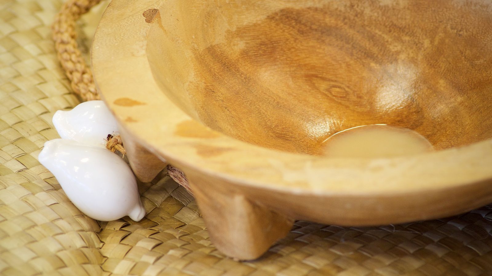  Kava bowl on woven mat next to shells