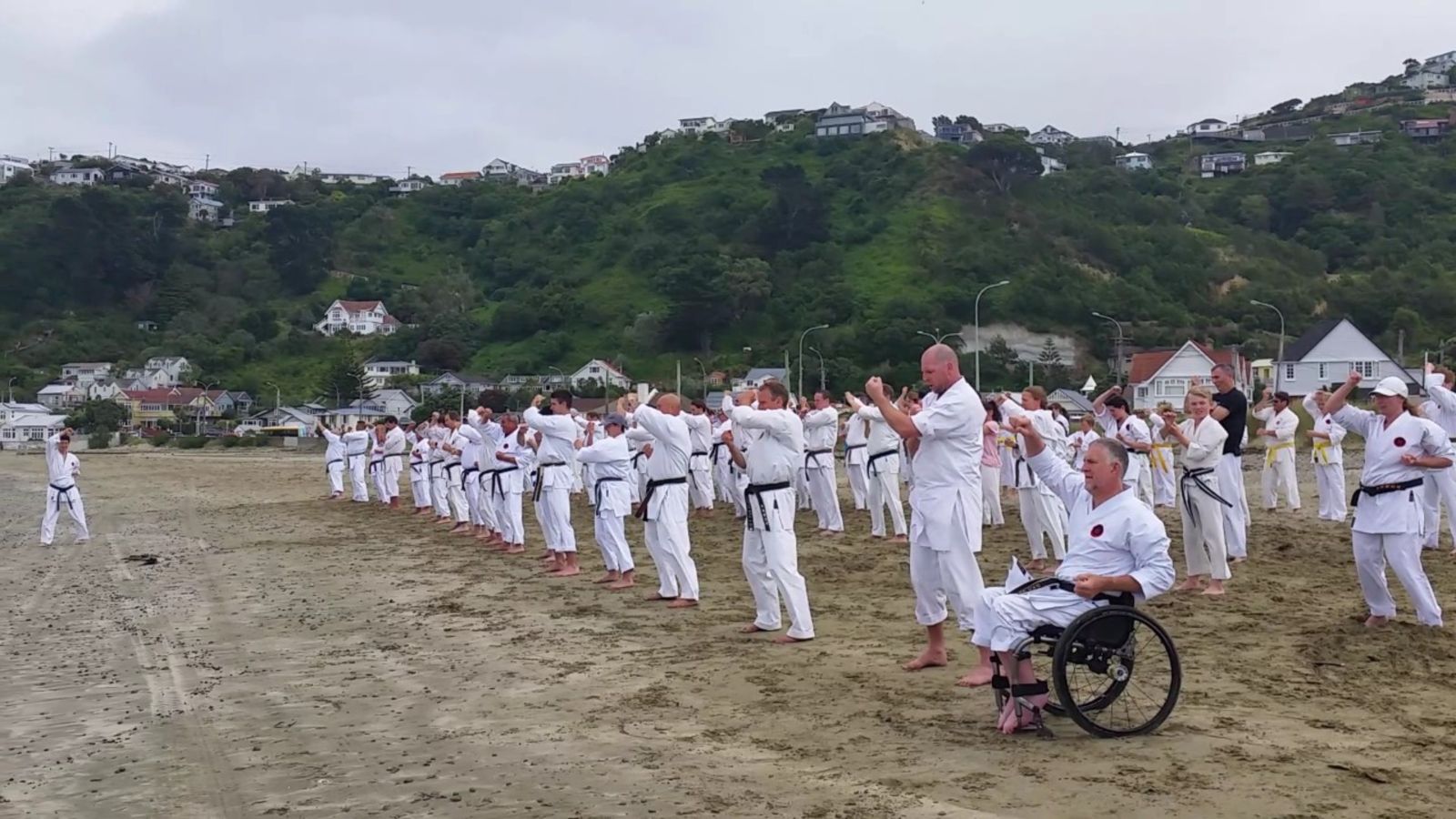 Karate training session on the beach.