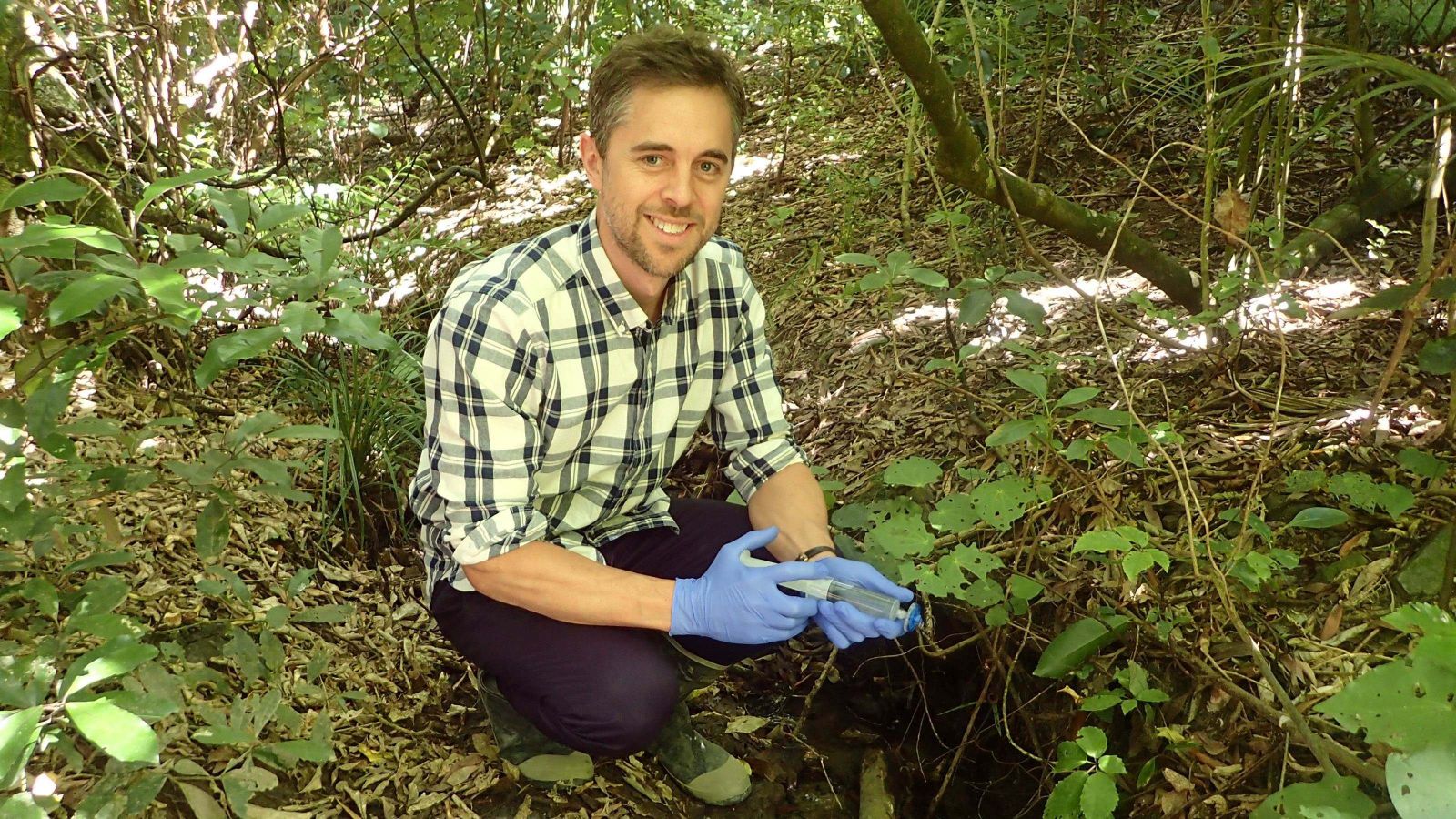 Shaun Wilkinson in the field, holding a syringe