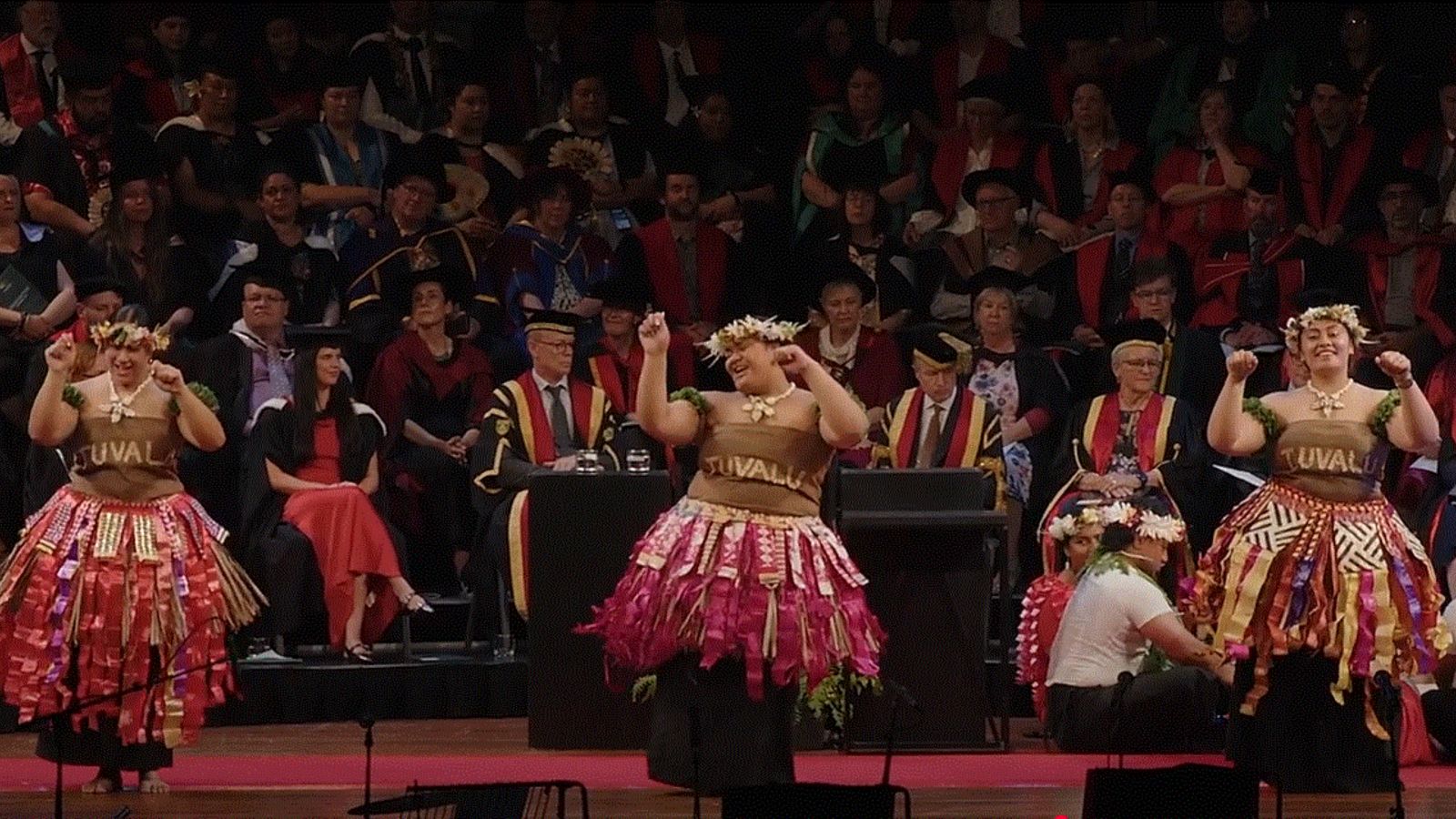 Three  women dancing at the graduation ceremony at the Michael Fowler Centre