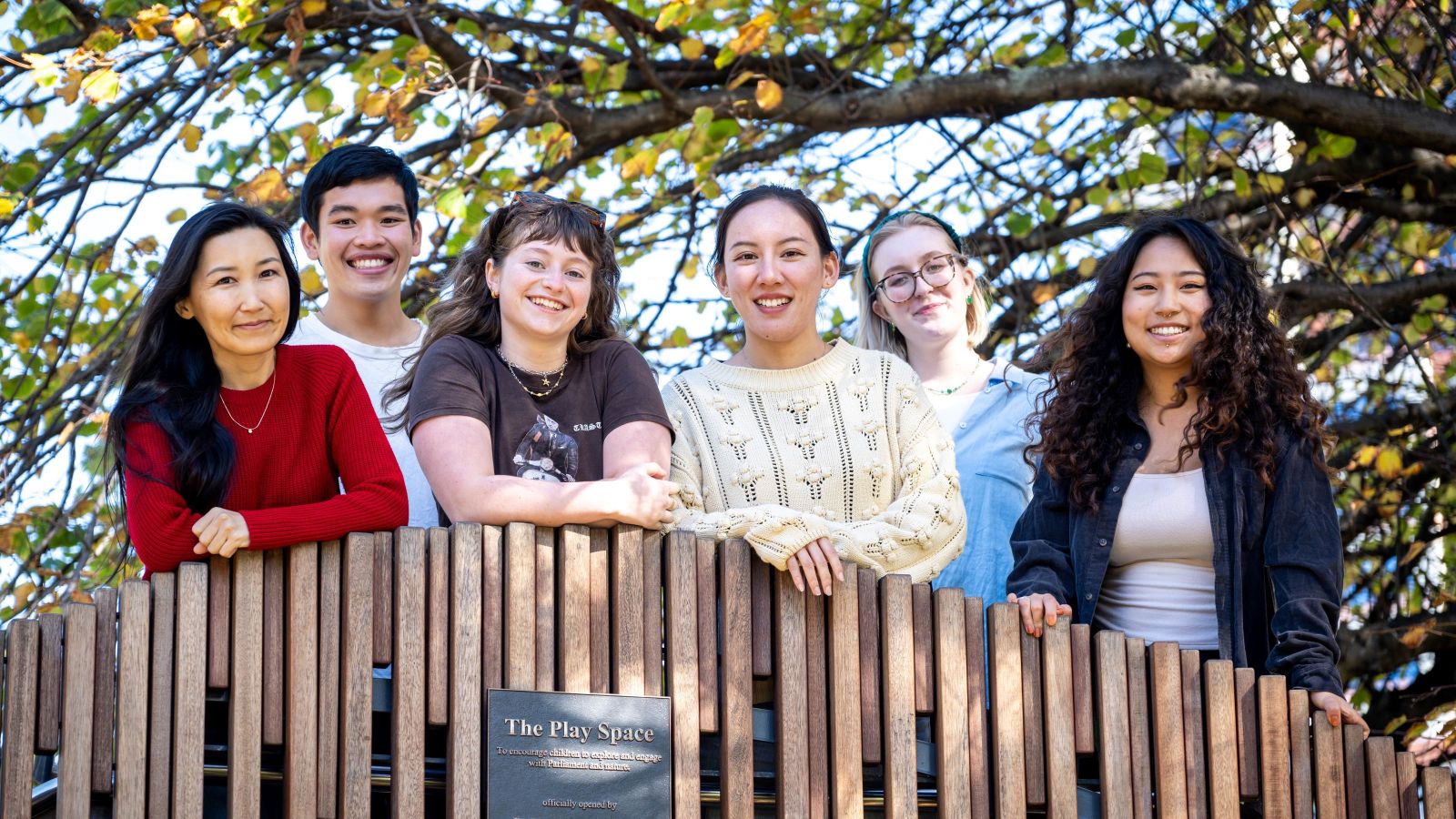 Echo with her TAP student ambassador group lined up together on a bridge overpass