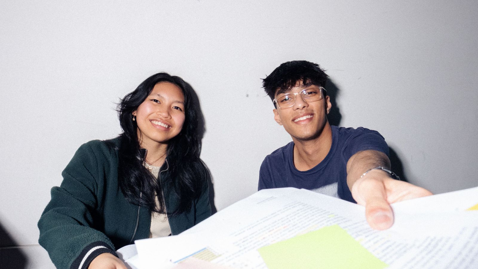 two students handing you their work
