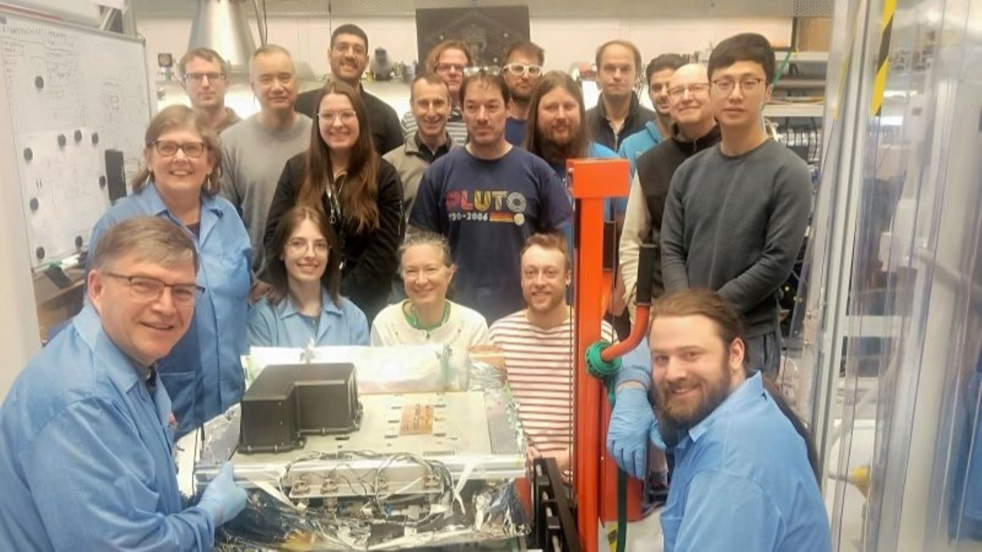 scientists from RRI stand in a group behind their rocket tech