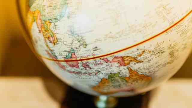 A world globe with a golden backlight.
