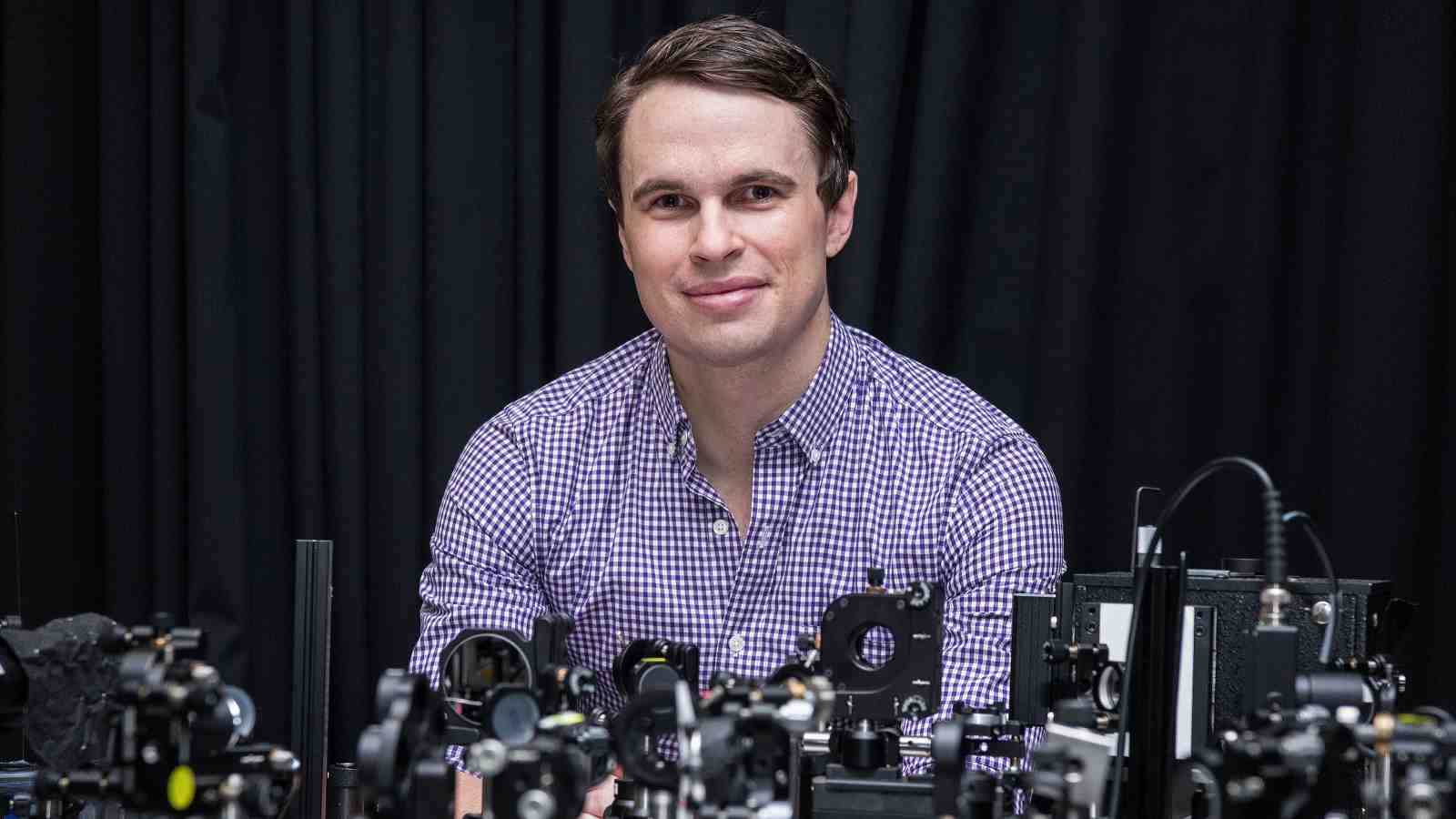 A prolie image of Nick Monahan with complex laser equipment.