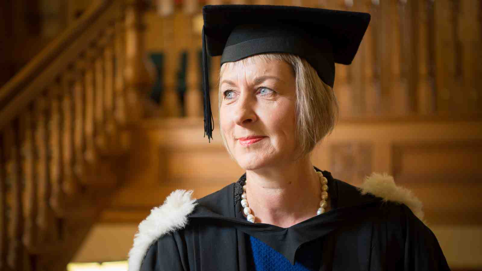 Sue Scutter in front of the stairs at the Law School.