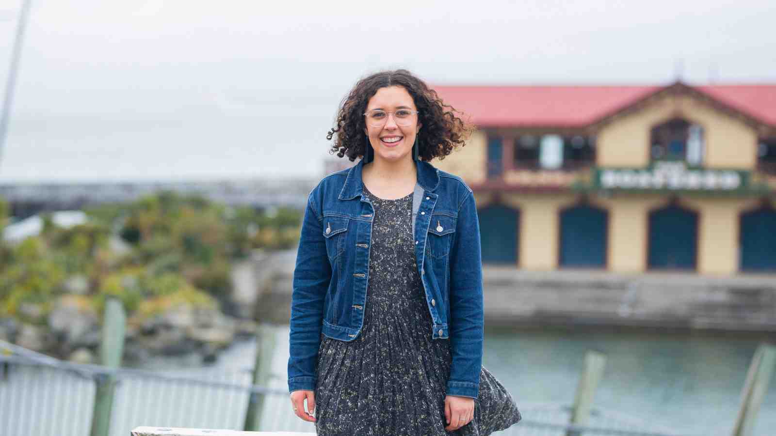 Isabella Lenihan-Ikin stands in front of the Wellington waterfront