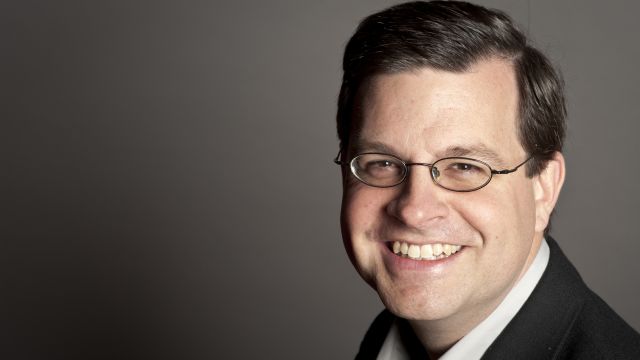 Dr Brian Biettrich against a gray background.