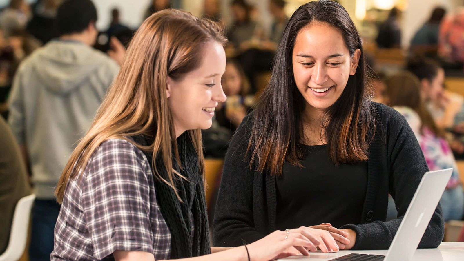 Girls studying from laptop in Hub at Kelburn campus.