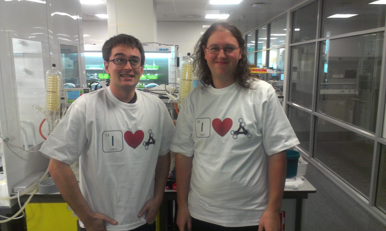 Two male students in matching white tshirts that read, "I heart cyclopropanes".