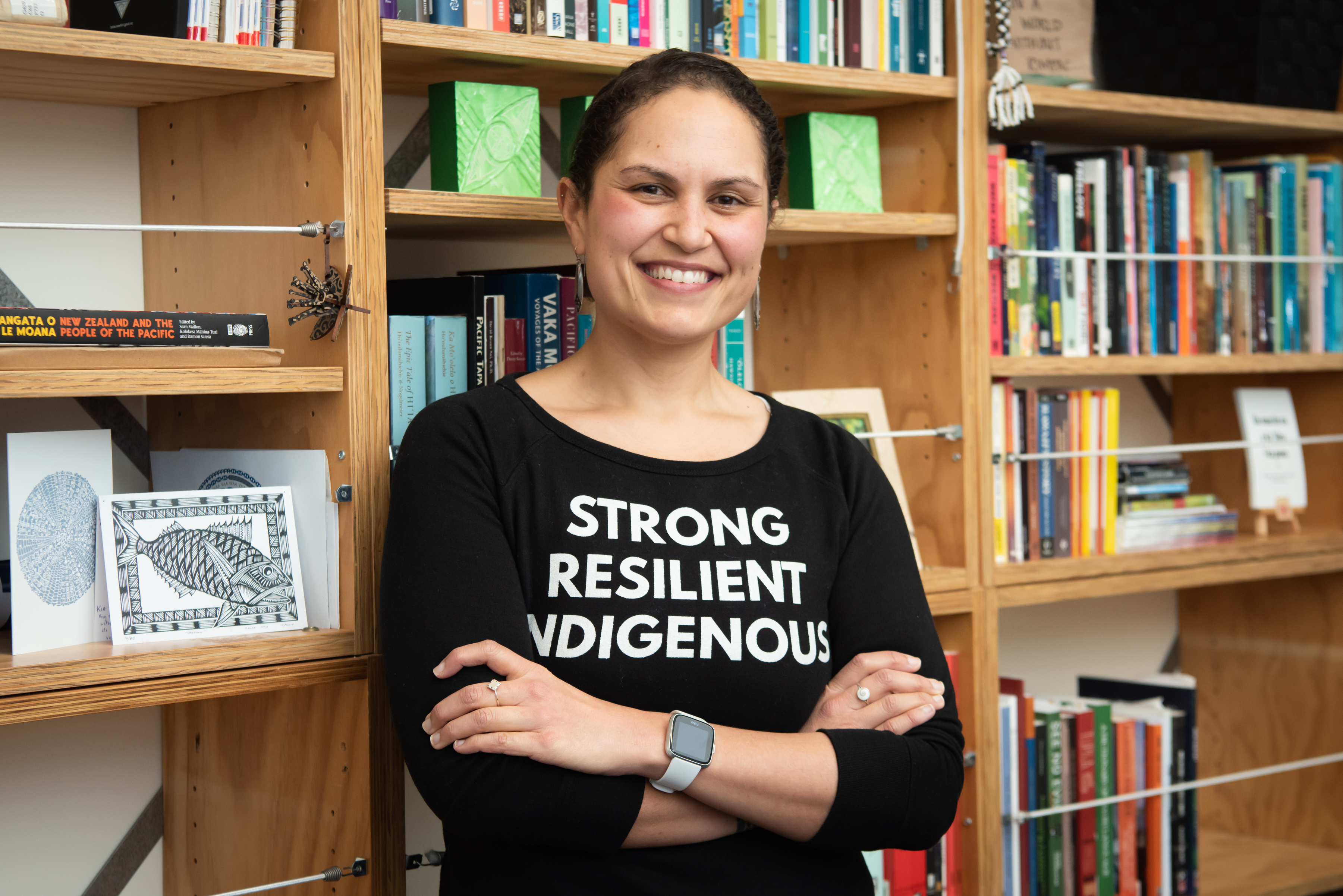 Pacific Studies lecturer Emalani Case photographed in her office with books in background.