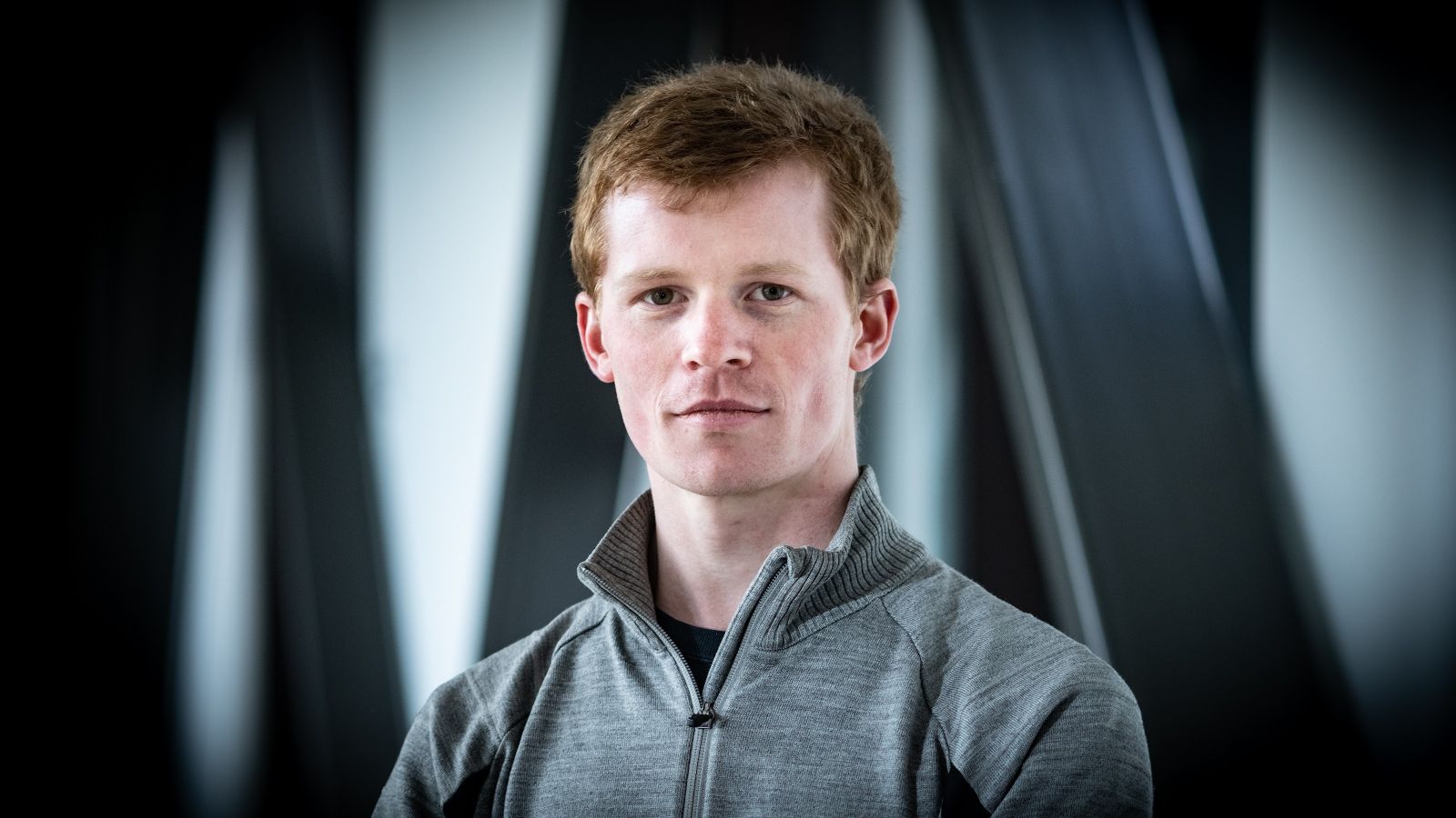 Portrait photo of Malcolm Jones in front of blurred steel girders