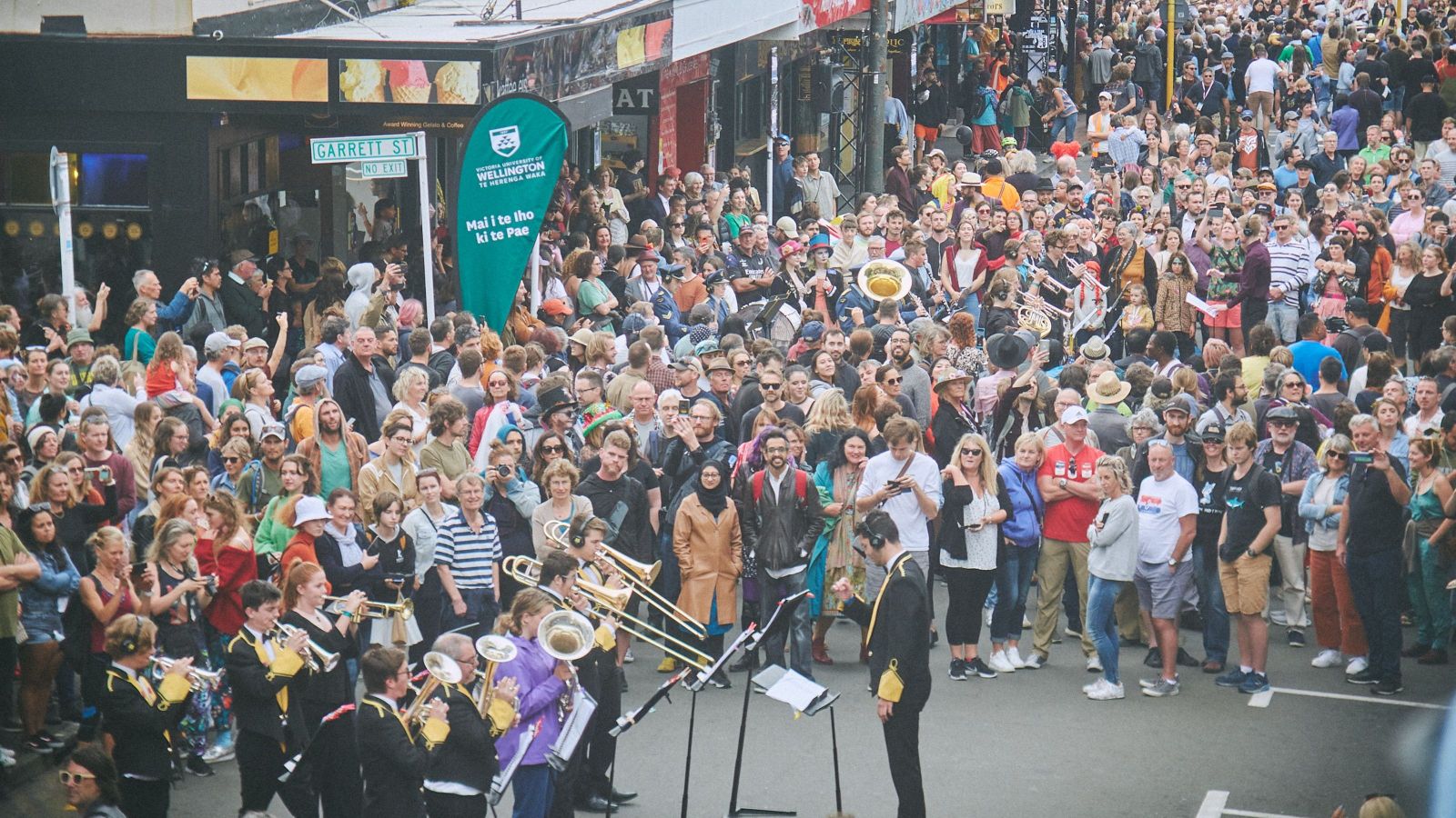 Image of the brass band performing to a crowd at Garrett st. 