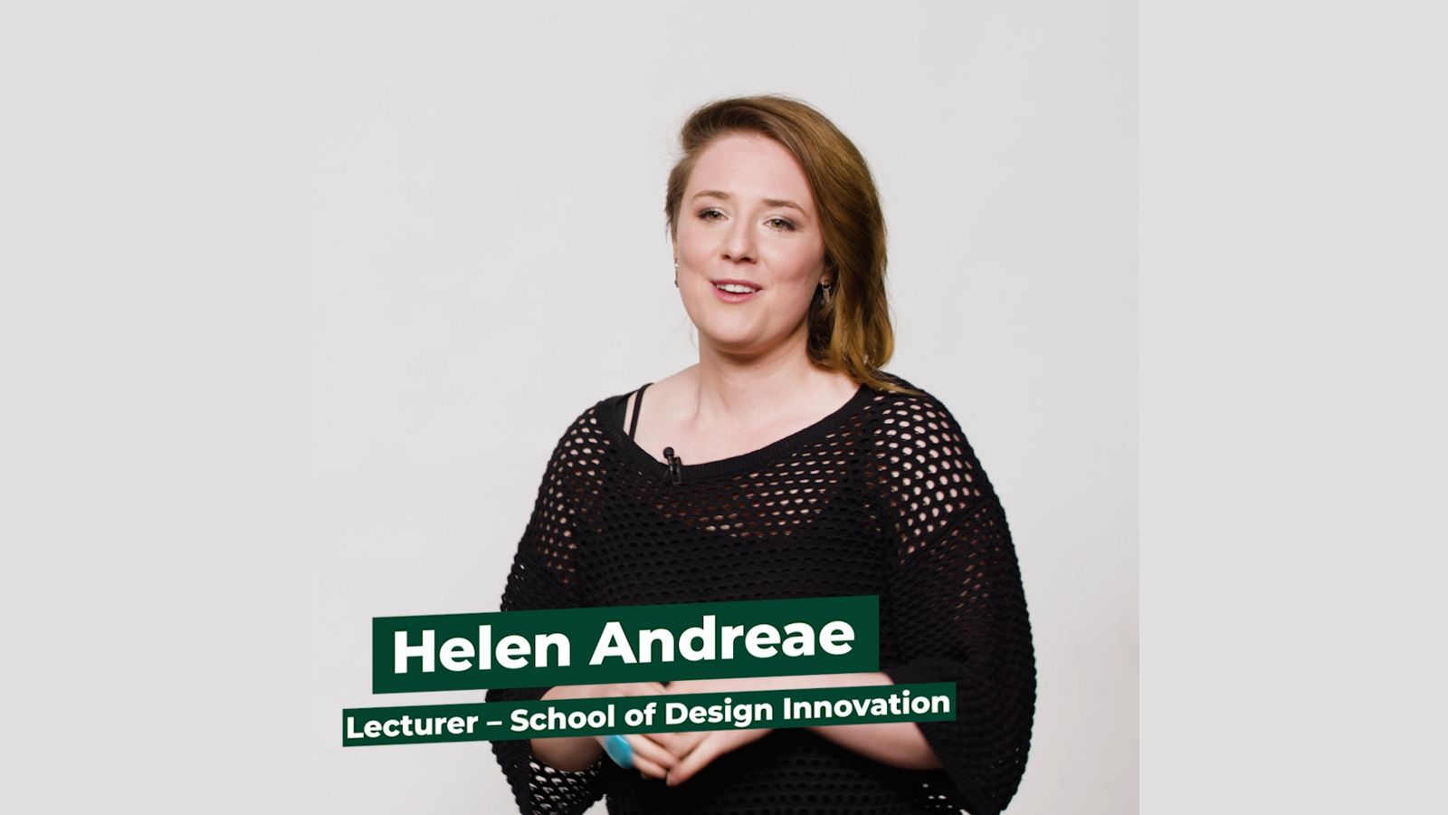 Lecturer Helen Andreae stands facing camera against a white background