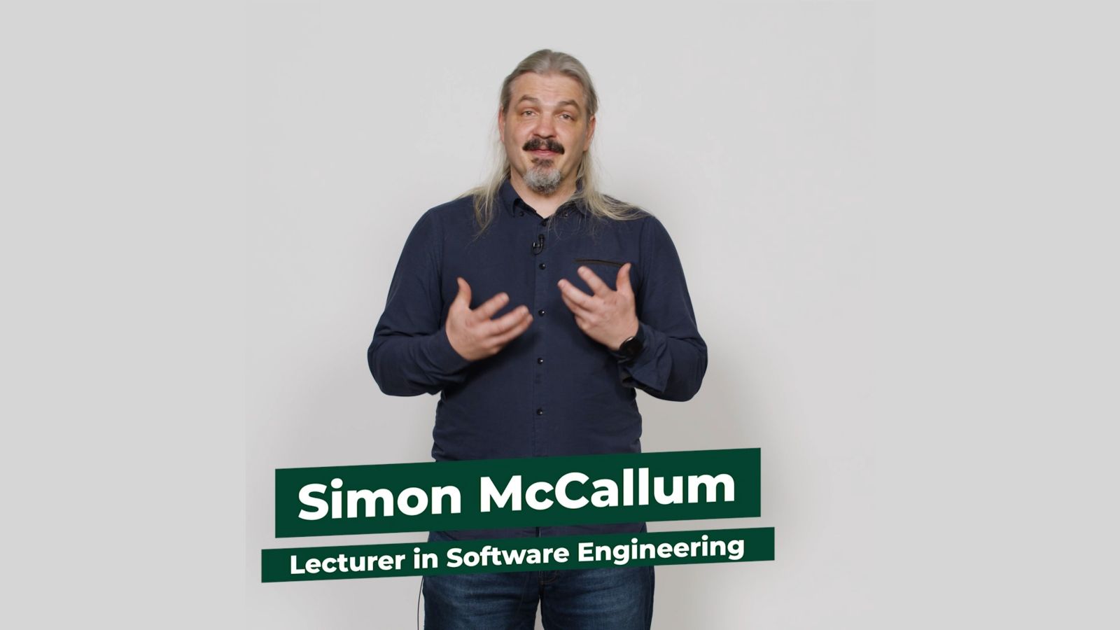 Software Engineering lecturer Simon McCallum stands facing the camera against a white backdrop.
