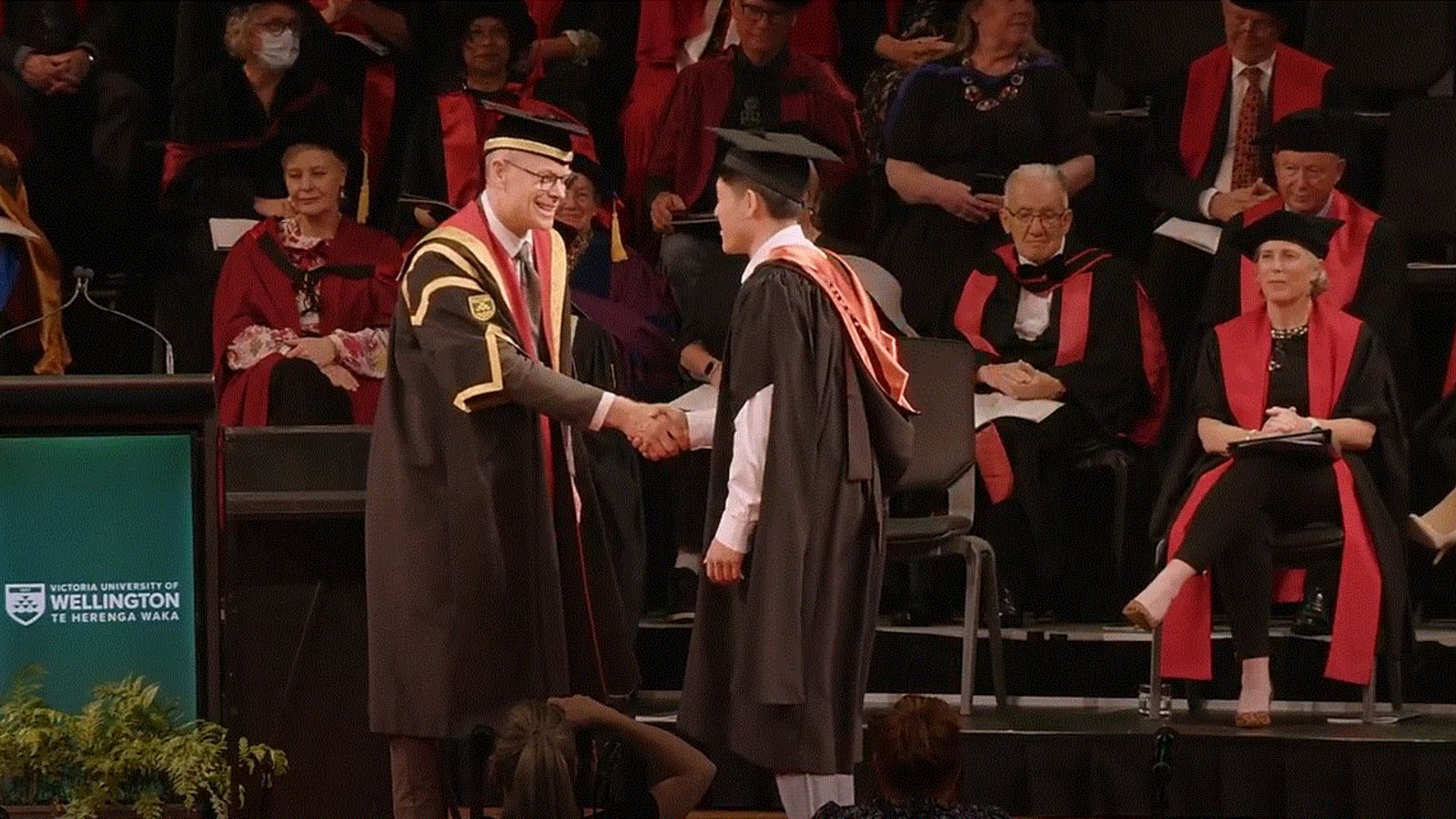 A graduate shaking the hand of Vice-Chancellor Nic Smith