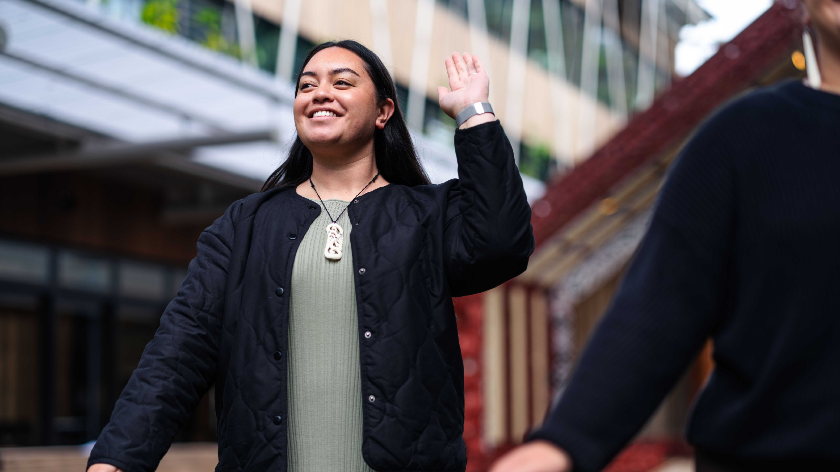 Young woman on the atea at the marae performing kapa haka