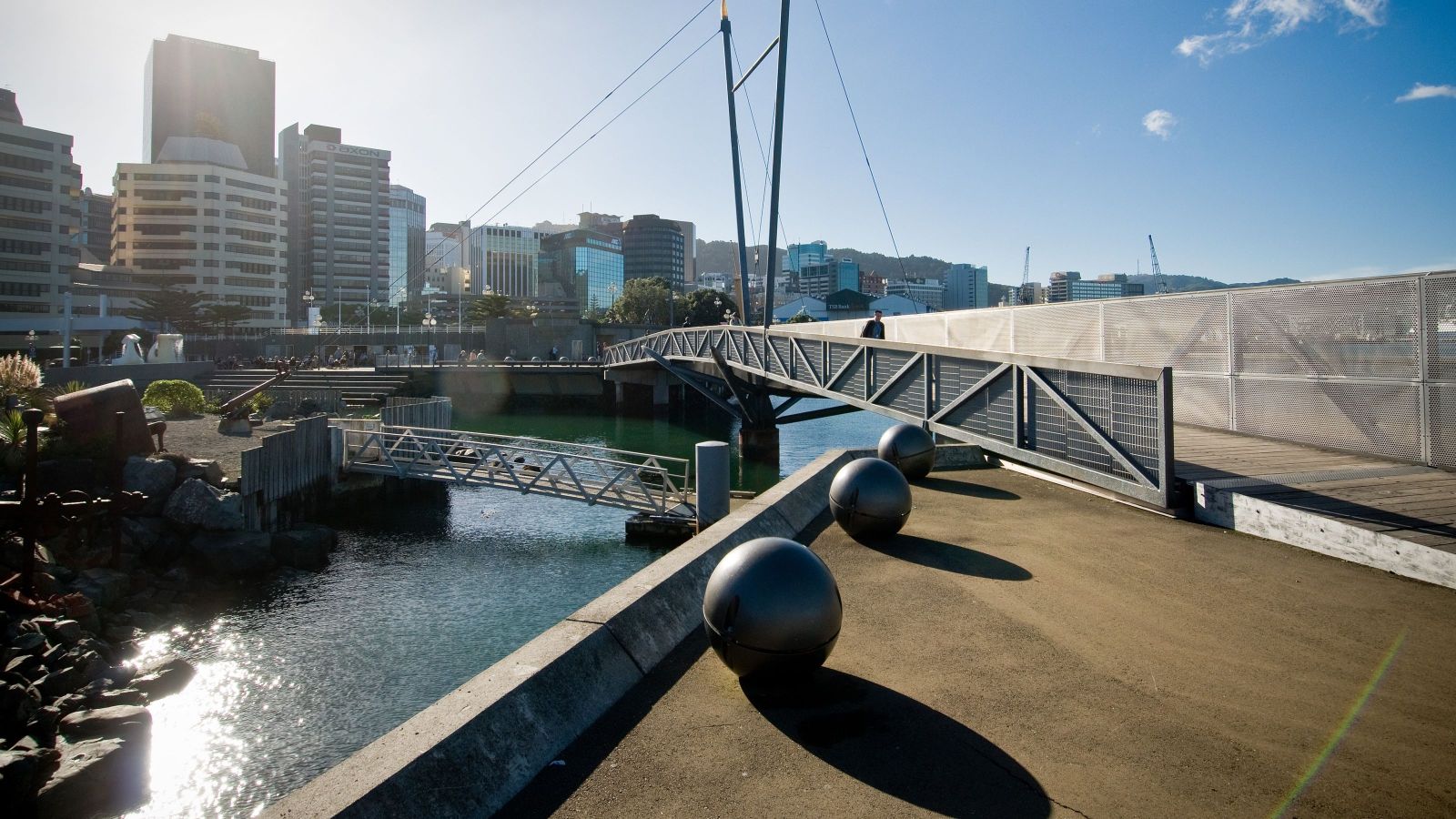 Wellington waterfront walkway and bridge with city buildings in the background.
