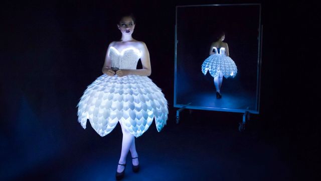 The dress 'Ester' is white with LED lights underneath lighting it up/