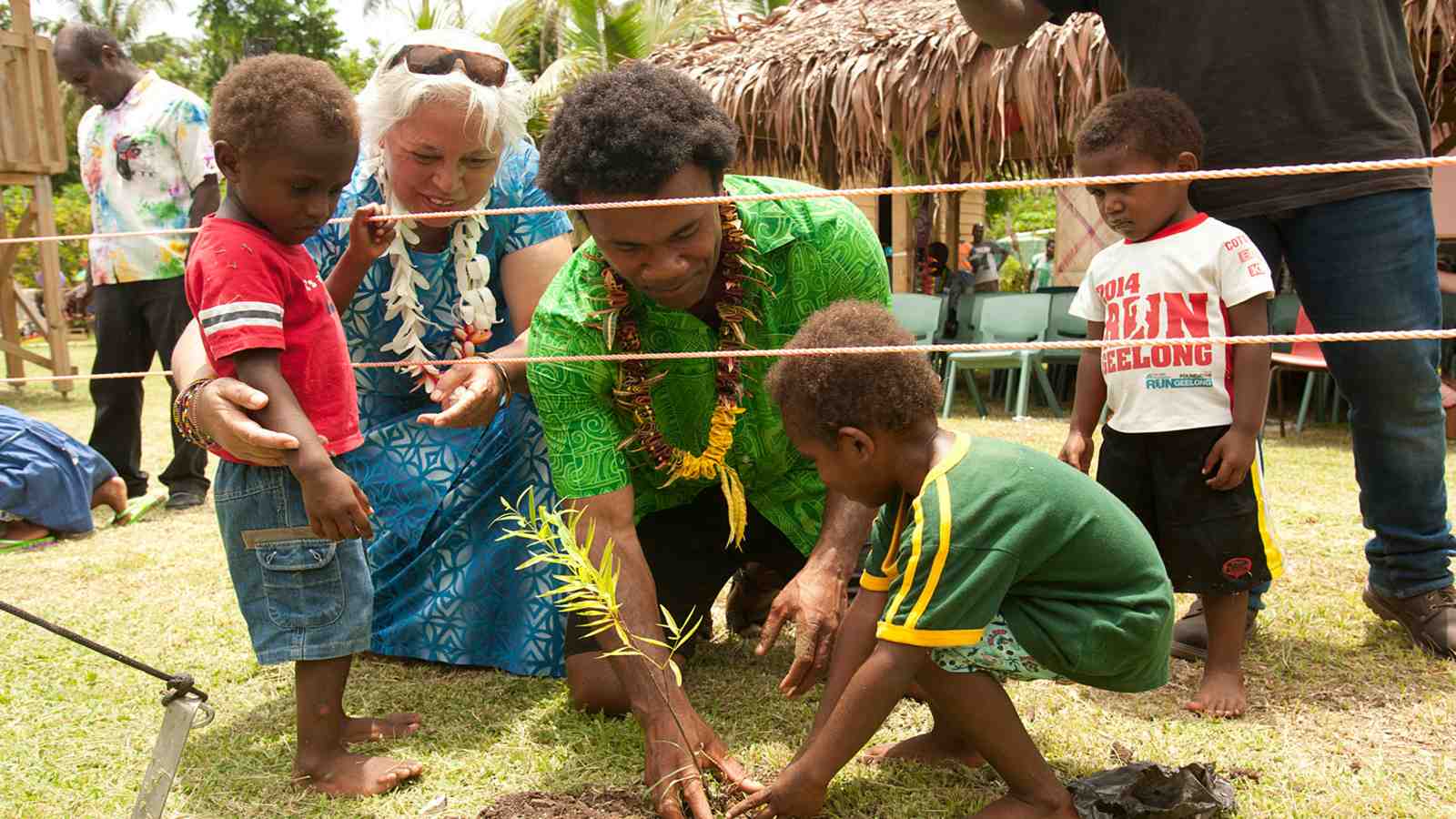 Victoria University representatives help local children plant a tree at the opening of the new early childhood education centre in Manua, Vanuatu – Hon. Luamanuvao Winnie Laban and Dr Pala Molisa from Victoria University help local school children plant a tree at the opening of the Tauawia Early Childhood Resource and Research Centre in Manua, Vanuatu. Photo: Murray Lloyd Photography.