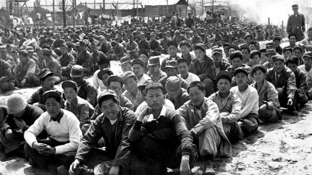At the United Nations’ prisoner-of-war camp at Pusan, North Korean and Chinese prisoners are assembled in one of the camp compounds.