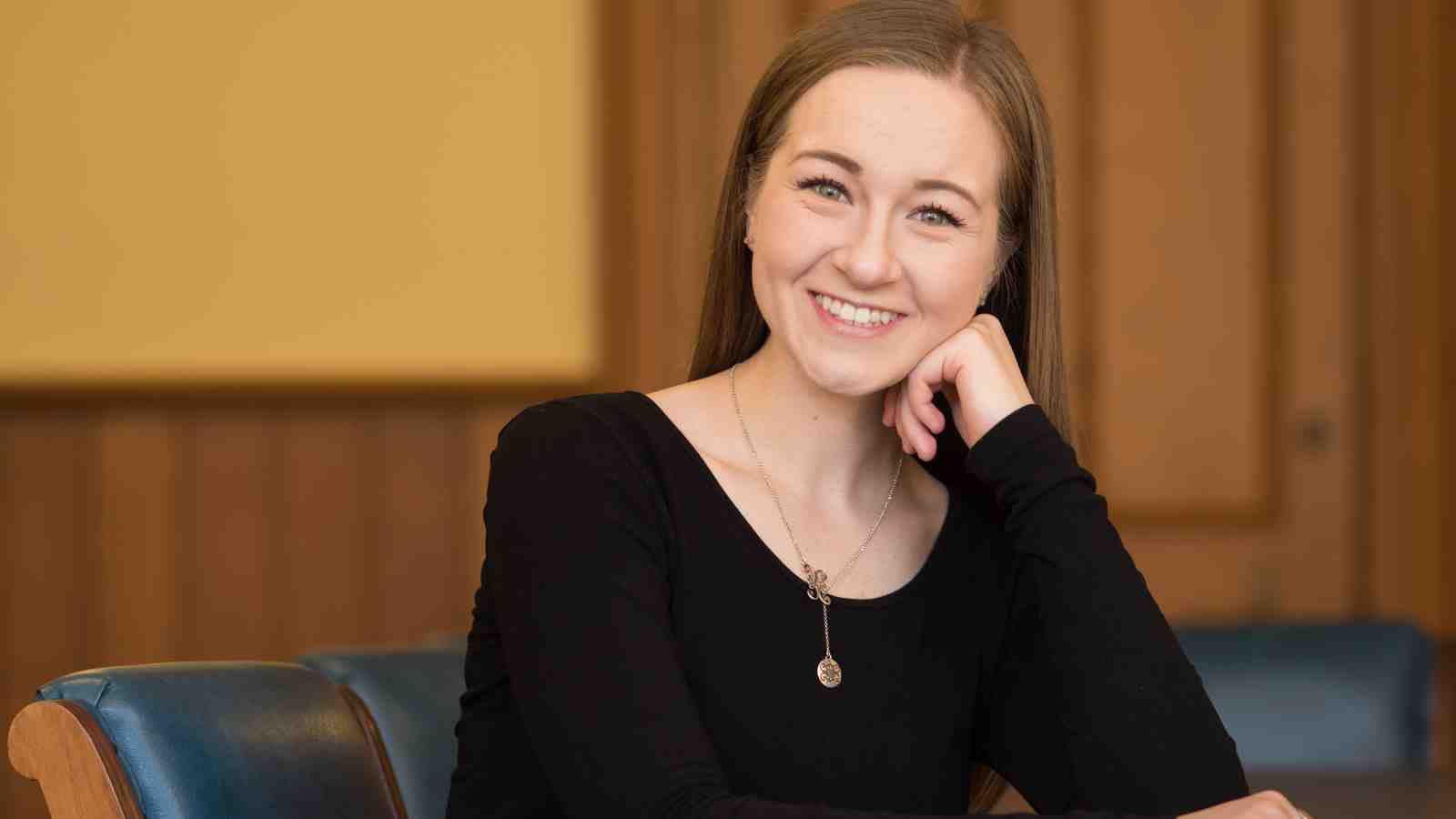 Hannah Martin sits on a chair looking at the camera