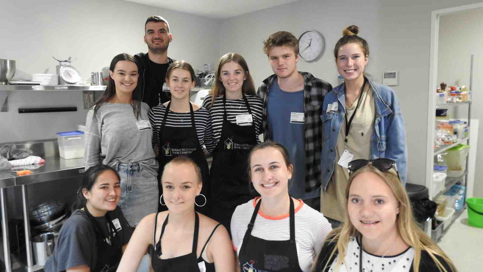 A group of students standing in the kitchen of Ronald McDonald House