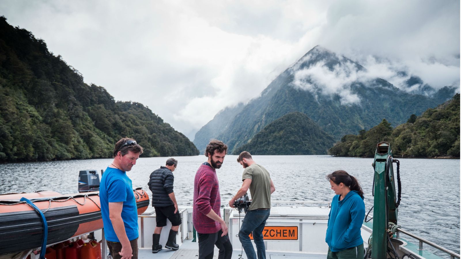 Extraordinarily beautiful and steep sided mountains, covered in a lush virgin forest, surround Professor James Bell's research crew aboard the Southern Winds vessel as they explore the serene waters of the Fiordland Marine Area, Te Moana o Atawhenua.