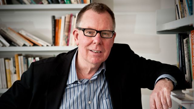 An image of Mark Williams in an office with book shelves.