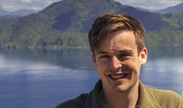 A profile image of Paddy Gerard with a lake and hills in the background.