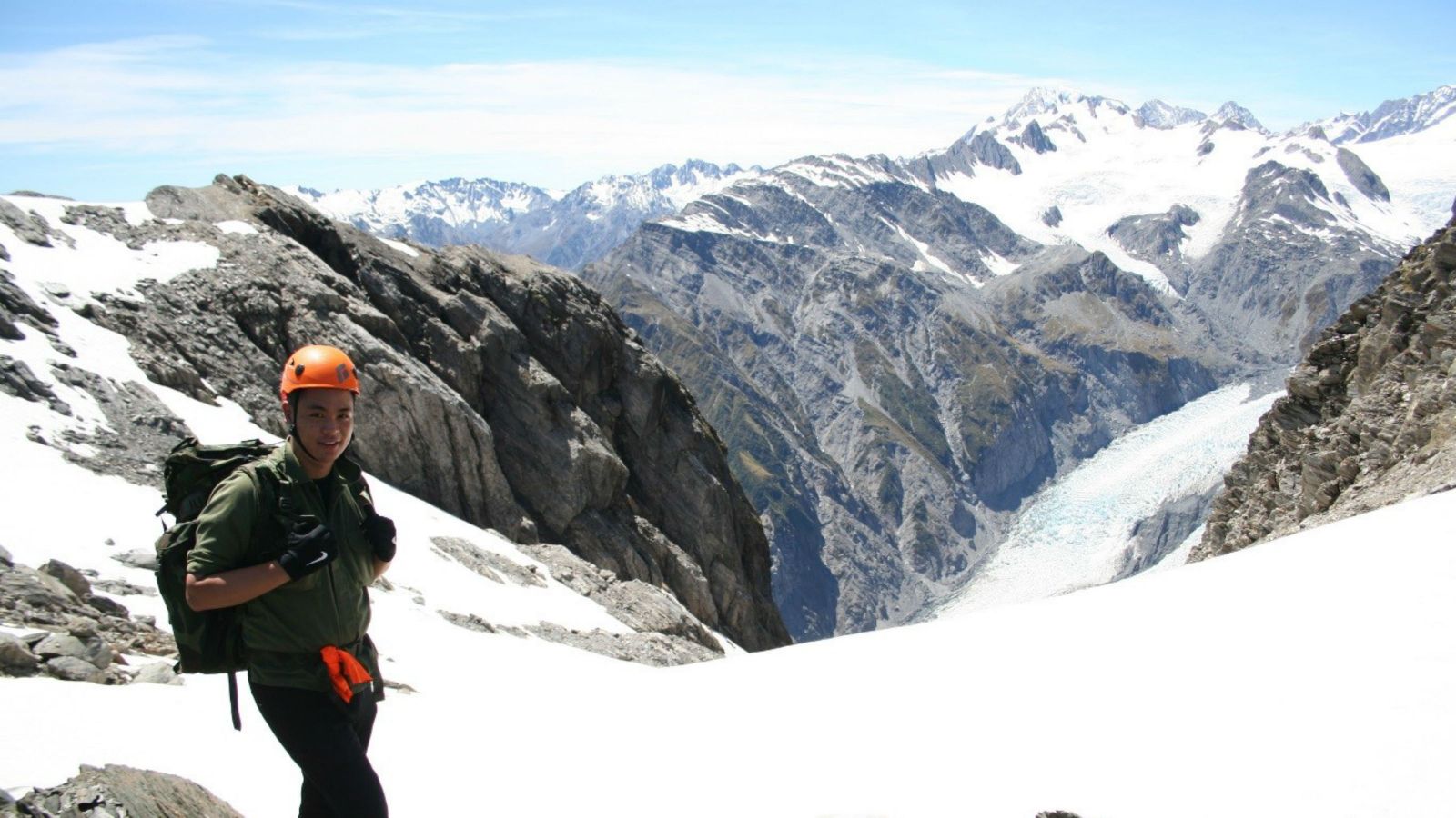Justin Liu on mountain Justin Liu summiting Tower Saddle on the West Coast in search of botanical specimens Tower Saddle, West Coast, South Island, New Zealand.
