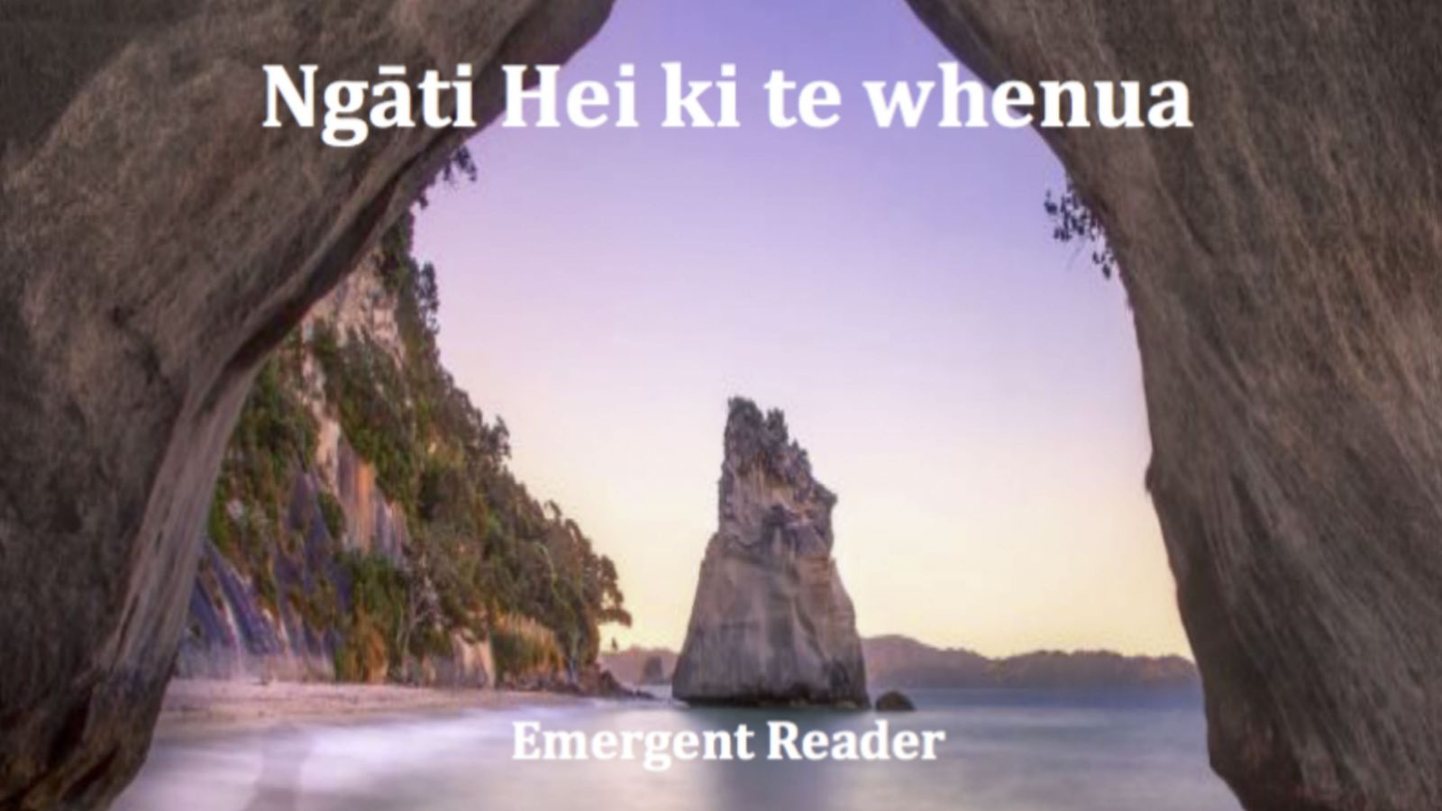 An image taken through a rocky arch on the shoreline of the ocean, looking out at a tall rock beside a sttep hill, under a purple sky, with text that reads, Ngāti Hei ki te whenua, Emergent Reader.