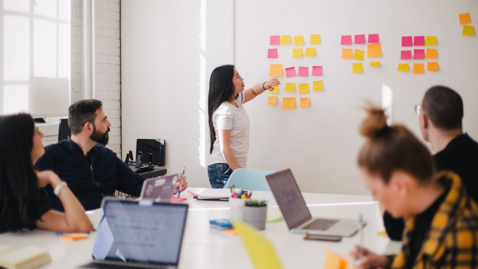 A students facilitates a meeting with sticky notes.