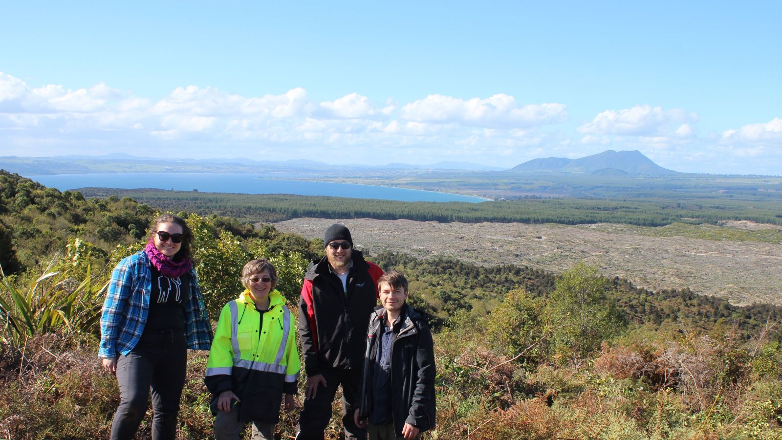 Ellie Mestel, Professor Martha Savage, Dr Simon Barker, and Dr Finn Illsley-Kemp with Tauhara volcano in the background.